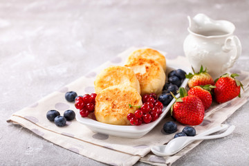 Cottage cheese pancakes with berries. Selective focus. Russian cheesecakes. Copy space