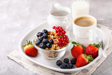 Breakfast - muesli, berries and coffee. Selective focus. Copy space