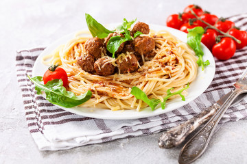 Spaghetti with meat balls in a plate on a table. Selective focus. Copy space