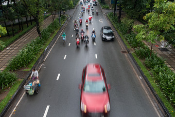 HO CHI MINH, VIETNAM - MAY 11 2017: Motorcycle traffic in rain. Is located in the South of Vietnam, is the country's largest city, population 8 million