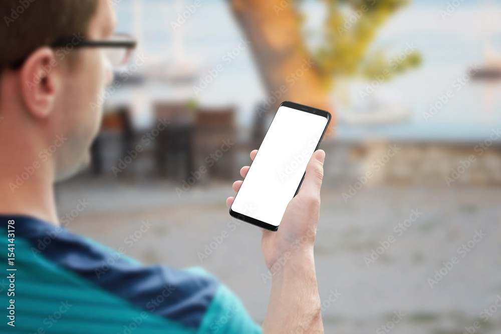Poster guy holding modern smart phone with isolated screen for mockup. phone with round edges.