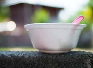 food container,plastic foam on green nature background