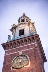 Krakow, Poland - 19th October. The Clock Tower of Wawel Cathedral in Krakow against a cloudy vignetted sky.