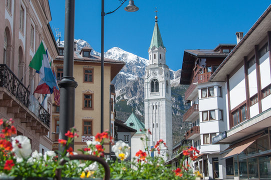 Cortina d'Ampezzo bell tower with flowers in springtime