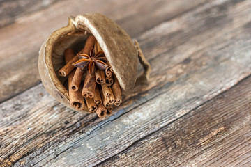 Ground cinnamon cinnamon sticks tied with jute rope on old wooden background in rustic style
