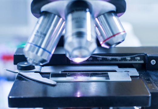 blurred microscope medical equipment in blue tone.