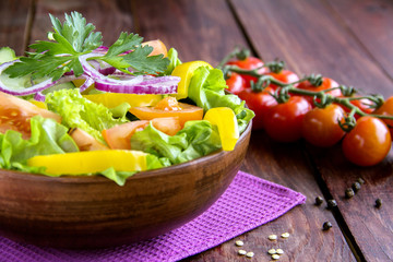 vegetable salad in wooden bowl on old wooden background Macro