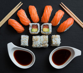 Salmon sushi and roll sushi on black