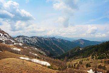 Springtime landscape of caucasus mountains with peaks covered by snow