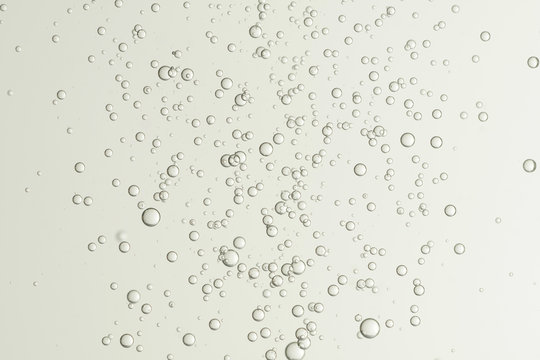Beautiful champagne fizz bubbles, soars over a blurred background.