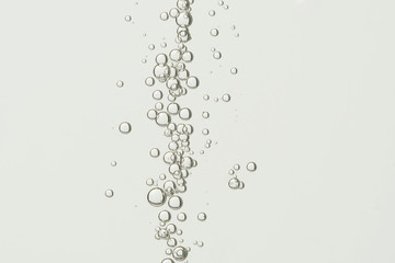 A fontaine of air bubbles is isolated over a light background