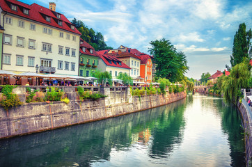 Naklejka premium Cityscape view on Ljubljanica river canal in Ljubljana old town. Ljubljana is the capital of Slovenia and famous european tourist destination.