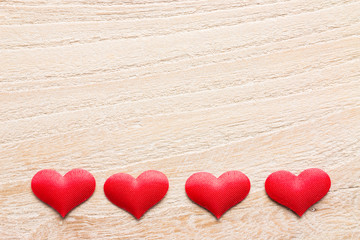Plakat Heart-shaped objects on a wooden background