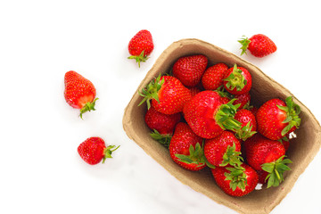Organic fresh strawberries fruit in paper box isolate on white background