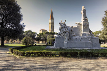 Arezzo, giardino del Passeggio del Prato con il monumento al poeta Petrarca. Sul fondo si staglia il campanile del Duomo.