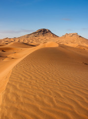 Fototapeta na wymiar sand dune with two peaks in background
