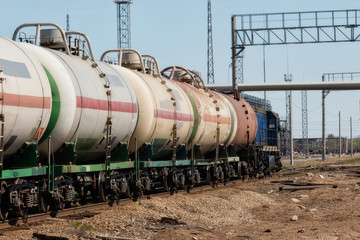 Fototapeta na wymiar A locomotive pulling a tank of chemicals on the rails