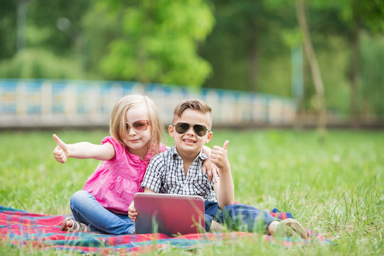 Boy And Girl With The Tablet