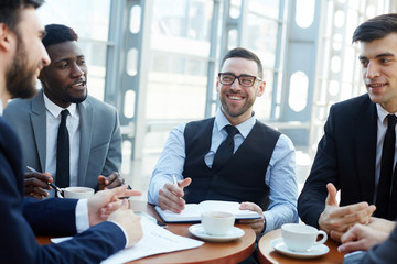 Several bankers having discussion at meeting