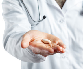 Female doctor holding a pills. Isolated on white.