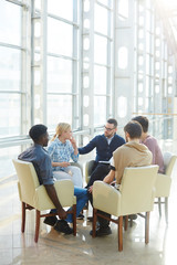 Obraz na płótnie Canvas Team of modern business people communicating at meeting