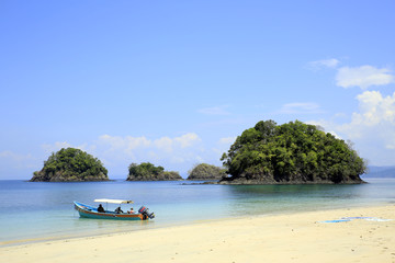 Fototapeta premium Beach with Small Isles and a Dive Boat. Coiba National Park, Panama