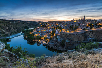 Fototapeta na wymiar Illuminated cityscape of Toledo,Spain and river Tagus
