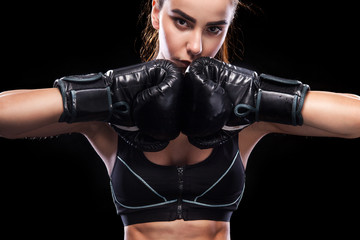 Sportsman muay thai boxer fighting. Isolated on black background. Copy Space.