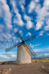 Fototapeta na wymiar Ancient windmill on hill top with rural landscape