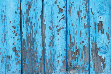 Old wooden fence with shabby paint use as background
