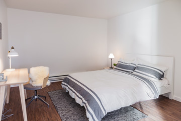 sleek modern bedroom with striped bedding