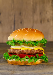 Classic deluxe cheeseburger with lettuce, onions, tomato and pickles