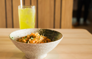 garlic rice with smoked salmon and ice greentea on wood table