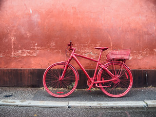 city bike painted red against red wall
