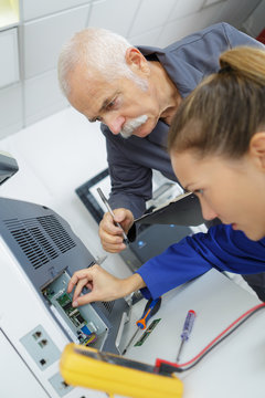 Technicians repairing electrical appliance