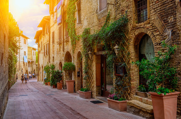 Old street in San Gimignano, Tuscany, Italy. San Gimignano is typical Tuscan medieval town in Italy - obrazy, fototapety, plakaty