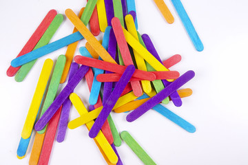 Colourful wooden sticks on white background