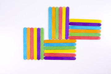 Colourful wooden sticks on white background