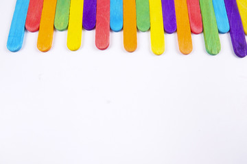 Colourful wooden sticks on white background