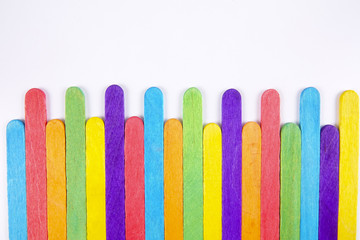 Colourful wooden sticks on white background