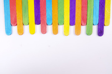 Colourful wooden sticks on white background