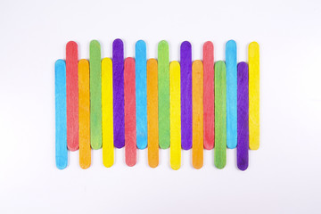 Colourful wooden sticks on white background