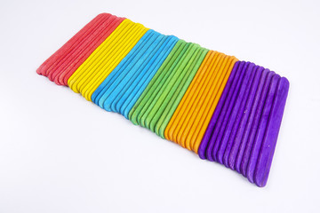 Colourful wooden sticks on white background