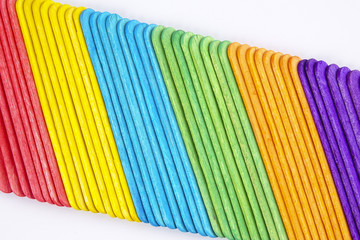 Colourful wooden sticks on white background