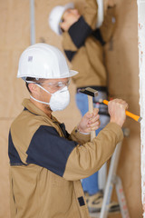 Workman using hammer and chisel - obrazy, fototapety, plakaty