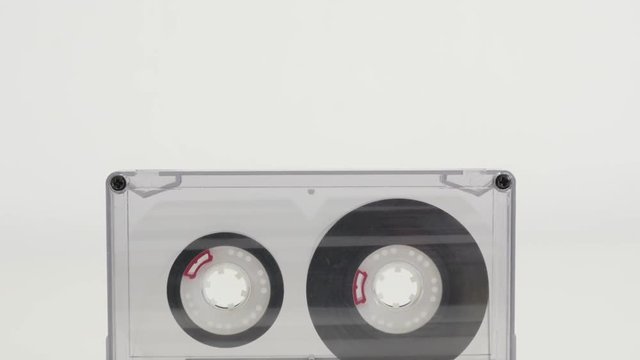 Retro audio compact cassette close-up 4K 2160p 30fps UltraHD tilting footage - Analogue music magnetic tape on white slow tilt 3840X2160 UHD video