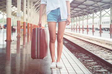 beautiful young asian girl traveling alone at train station, vintage tone 