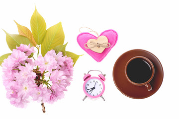 Bunch of sakura flowers, pink heart, alarm clock and coffee