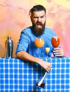 Brutal caucasian hipster with alcoholic cocktails and bar stuff