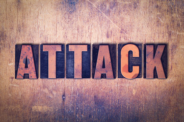 Attack Theme Letterpress Word on Wood Background